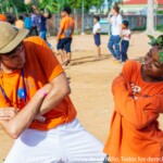 Enrique, dancing with a kid during an activity consisiting in making costumes.